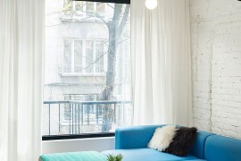 Twin coffee tables create a visual link between the living space and dining area