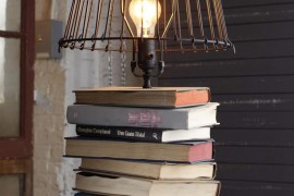 Upcycled industrial lamp with books for its base