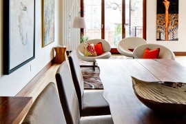 Wall art and accent pillows add color to the curated, modern living room