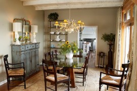Weathered buffet and antique mirror give the cozy dining room a shabby chic look