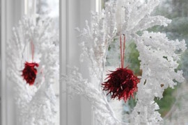 Wintery white and red wreaths hung in windows