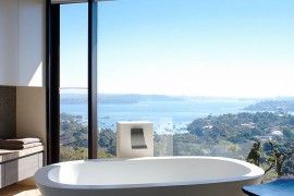 Wonderful framing of the distant view turns the minimal bathroom into a relaxing retreat