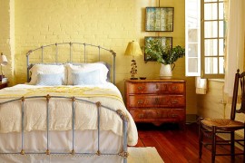 Yellow adds a fuzzy sheen to the eclectic bedroom