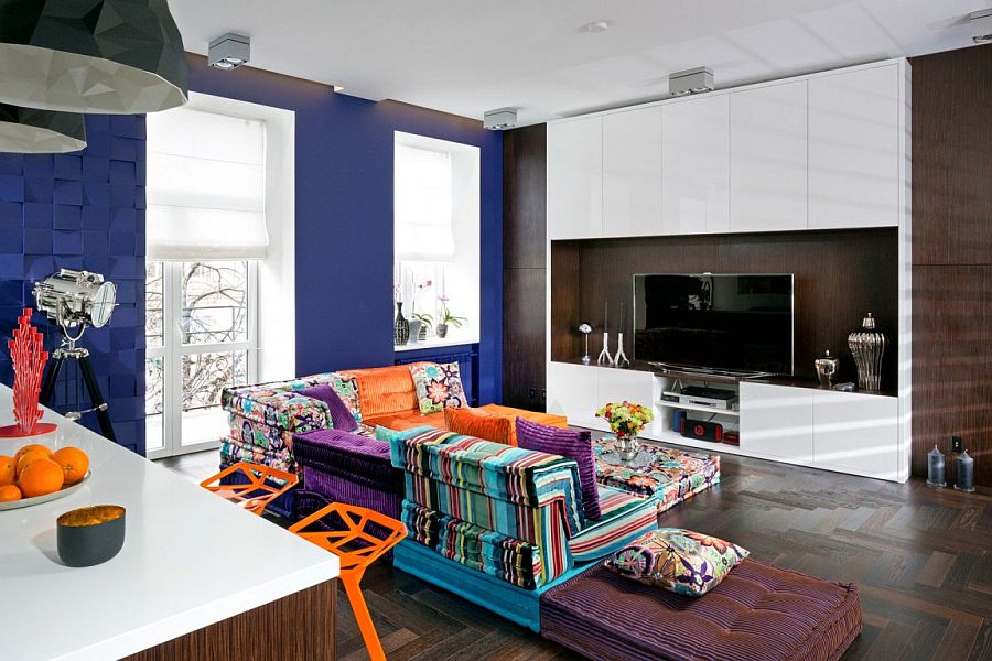 Gorgeous and colorful modular sofa by Roche Bobois sits at the heart of the home theatre guest room Unraveling a Secret: Small Apartment in Kiev Amazes with Cleverly Concealed Rooms