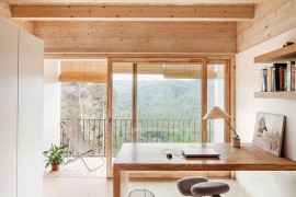 Home office with minimal white walls and an elegant desk design