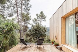 Minimal wooden deck of Casa LLP with a view of Collserola mount