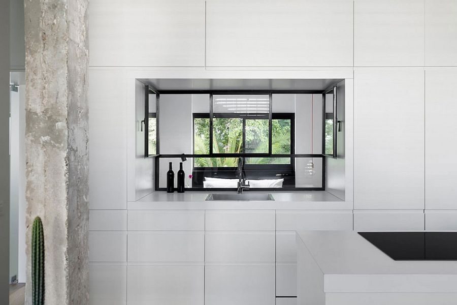 Window in the kitchen cabinets allows for passage of natural light into the bedroom