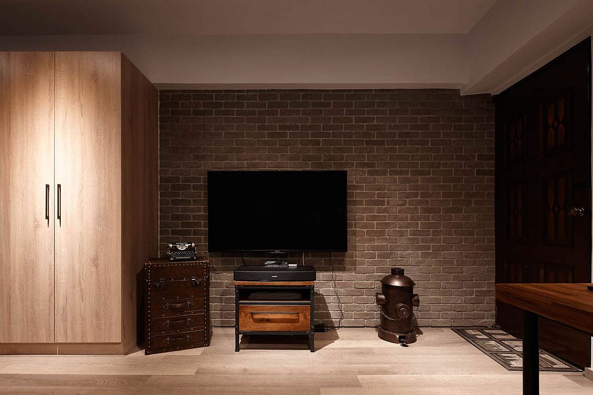 Brick accent wall section delineates the TV zone form the rest of the interior
