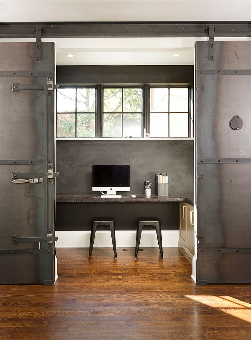 Dramatic sliding doors separate the small home office from kitchen and dining area