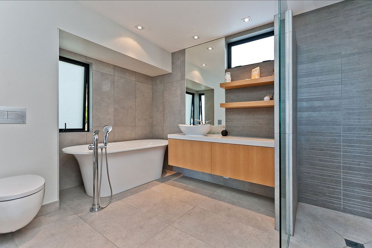 Modern bathroom with floating vanity, white bathtub and floating 