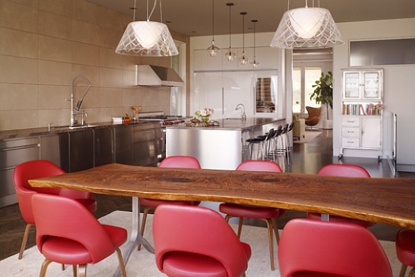 dining room with unusual shaped table and comfy red chairs