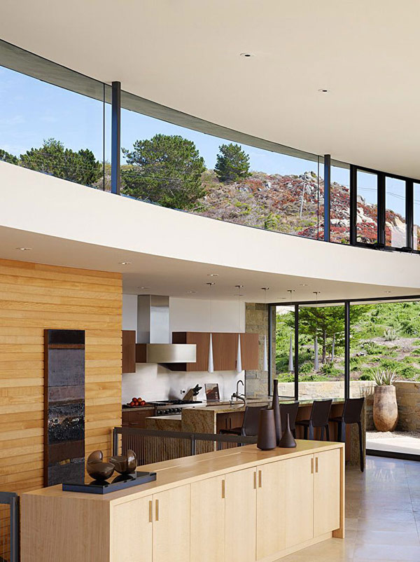 home perched on a cliff with ocean views 7 - wooden kitchen area with sleek dining space