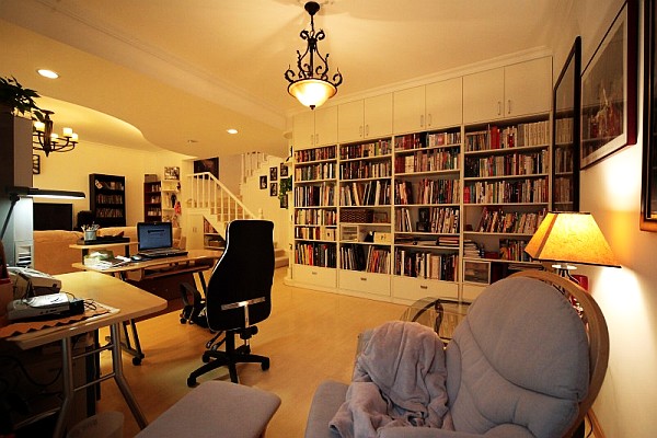 open space living room with home office desk behind sofa