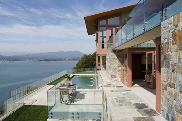 stone and glass house with pool