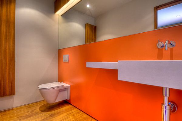 bathroom design with orange wall over white sink