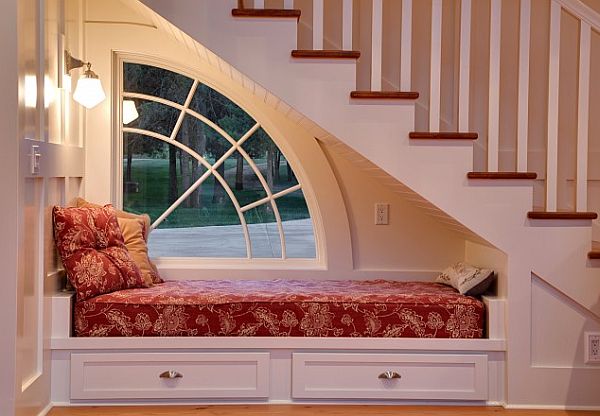 cool under staircase white and red reading nook idea