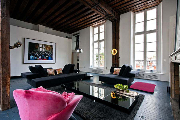 large living room with black sofa and pink lounge