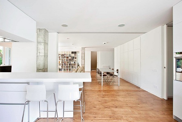 white contemporary living room with dining table and bookshelf