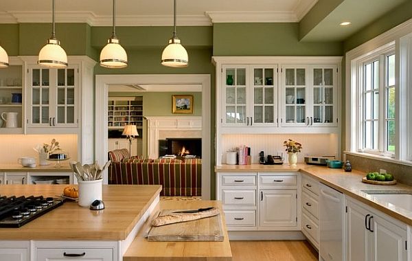 white-kitchen-cabinetry-with-wooden-furnishings-and-green-walls