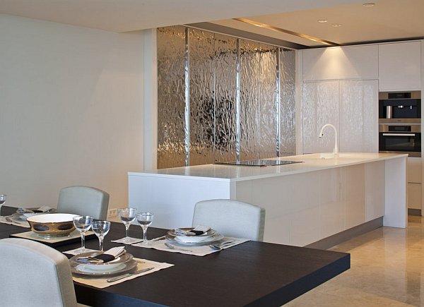 white kitchen island with white cabinets and modern dining table