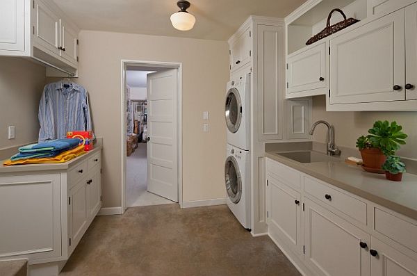 white modern laundry room with Cupboards and hanging rack