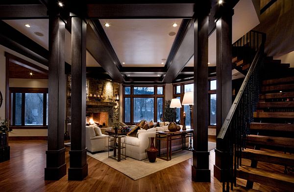 Cozy dark living room with wooden beams and staircase