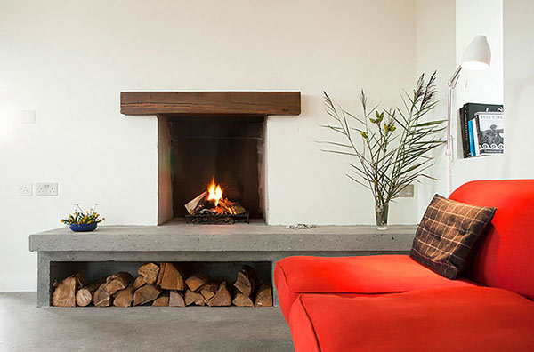 Modern Stone Hut orange sofa with wood fireplace