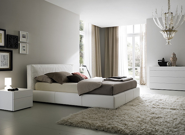 white and grey bedroom with elegant candlestick style chandelier