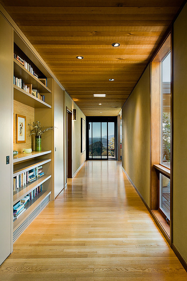 Hallway with stylish wall-enclosed bookshelf