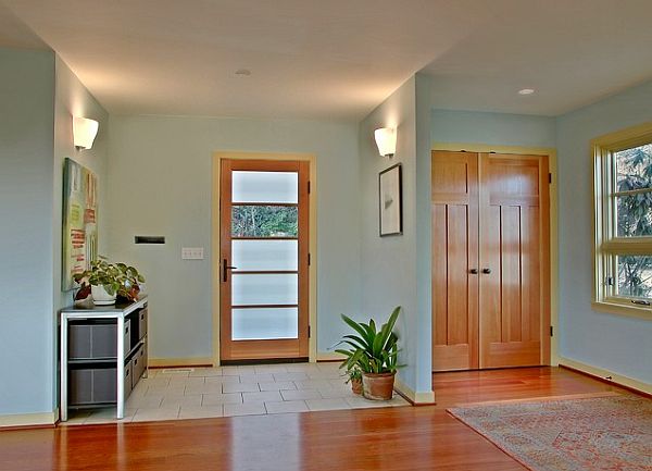 Full light glass entry door with wood trim in a very inviting entryway