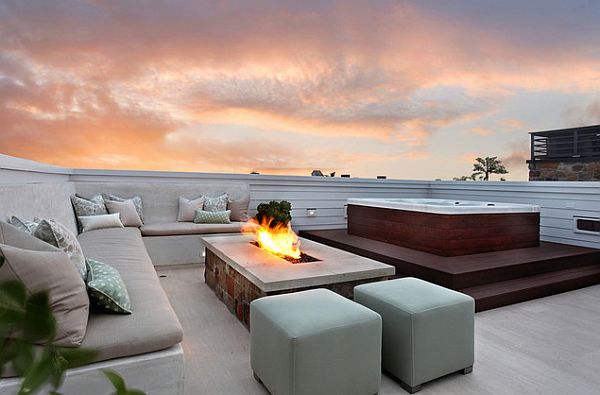 rooftop space with modern couch, outdoor fireplace and jacuzzi