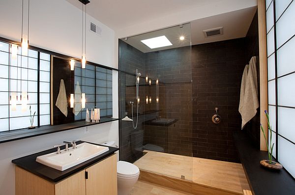 stylish bathroom with black tile and roman shower