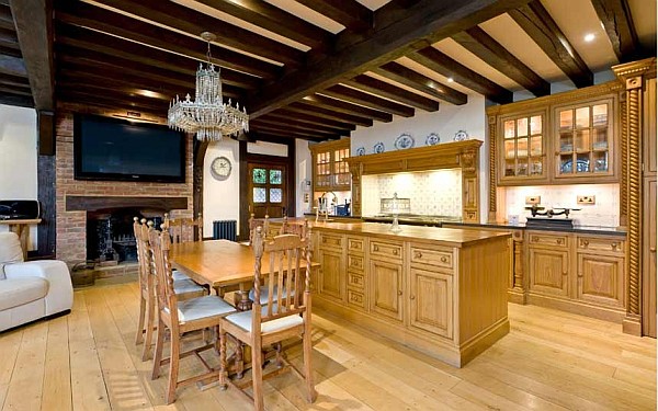 traditional wooden kitchen with exposed beams and granite work surfaces