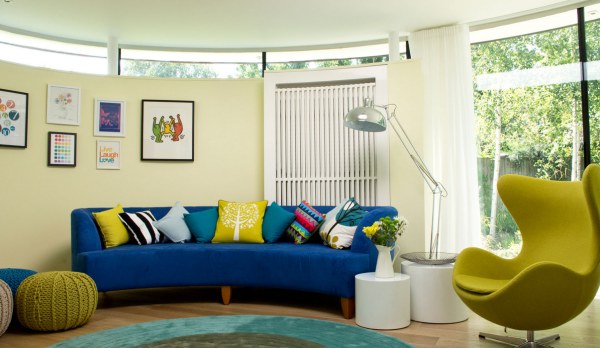 A curved blue sofa in a contemporary living room