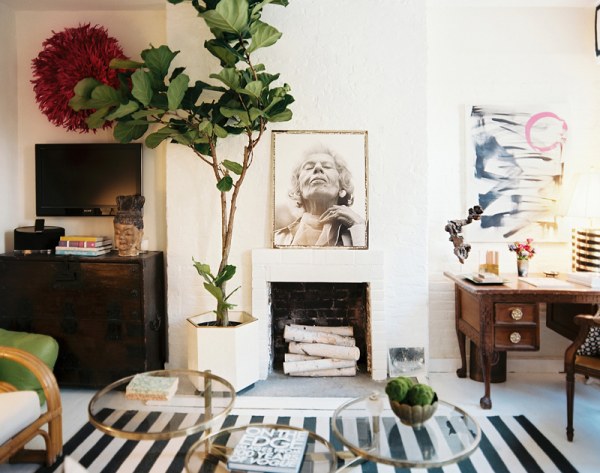 A flat-screen TV hangs above a living room chest