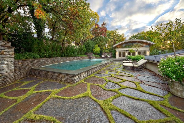 Grass-lined stone stands out on a poolside terrace