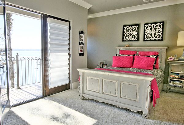 Grey bedroom with pink pillows for contrast