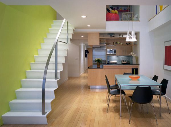 NYC-loft-with-modern-design-and-yellow-wall-behind-the-white-staircase