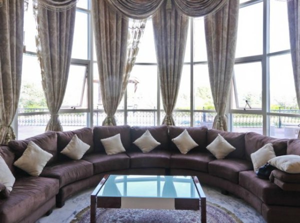 Ornate draperies and a plush sectional sofa