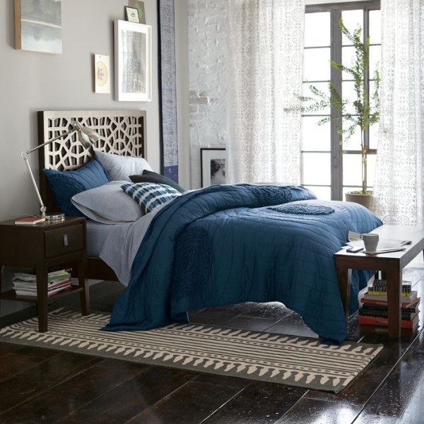 a light and airy bedroom with blue bedding