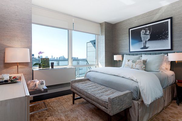 modern NYC bedroom with textural grass cloth wall covering and soft blue bedding