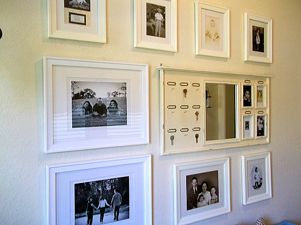 wall gallery of familiy pictures with white frames