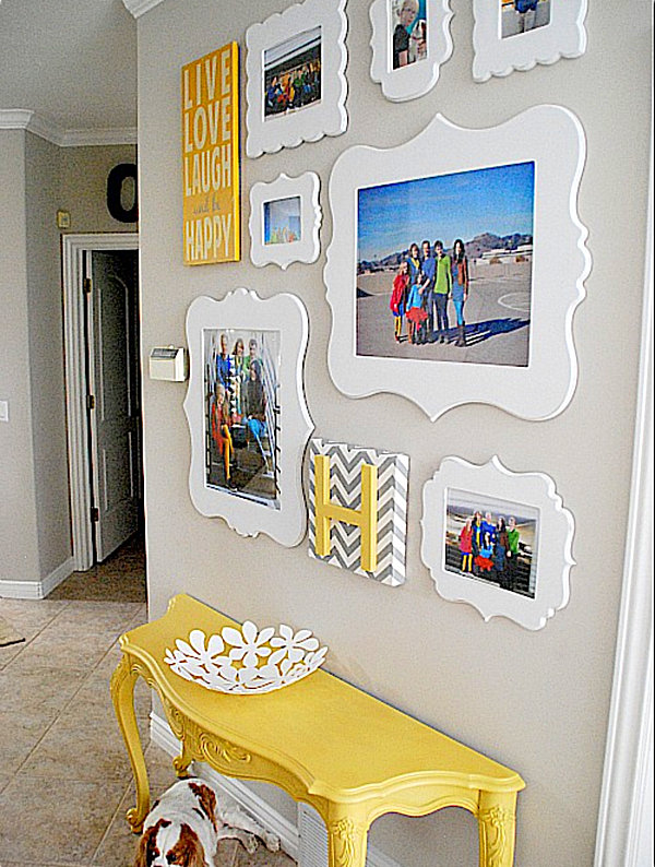 wall gallery of white framed family photos