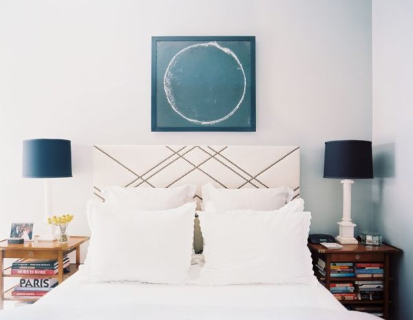 A bedroom with a geometric headboard