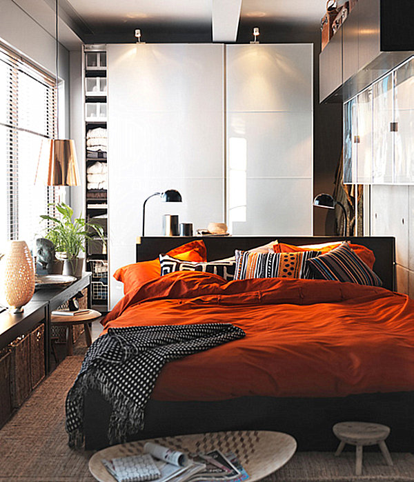A compact bedroom with a storage wall