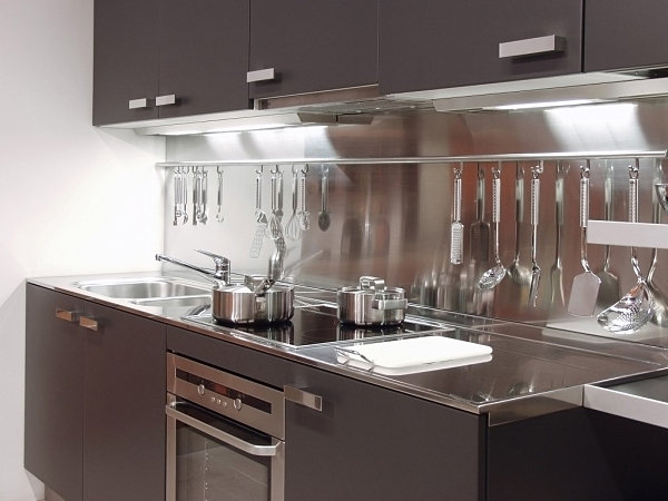 A modern small kitchen with metallic details