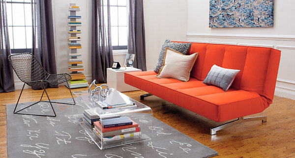 An orange sleeper sofa in a modern living room
