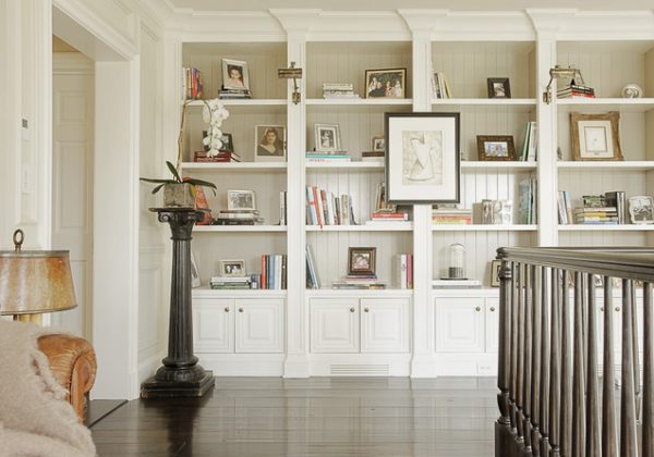 Art hangs from a bookshelf