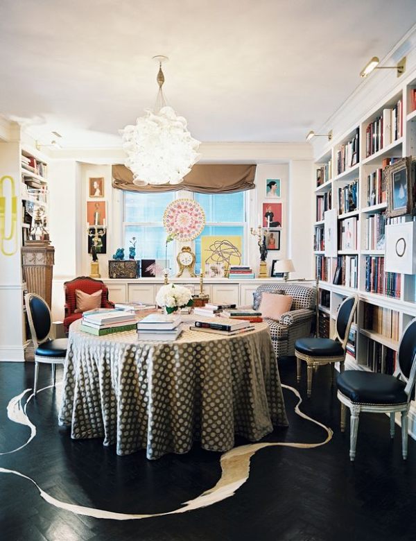 Art on a ledge and a bookshelf