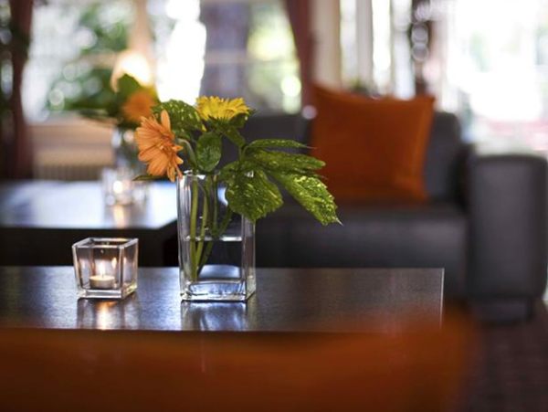 Earth-toned flowers in a glass vase